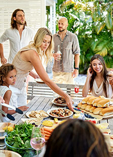 Family enjoying outdoor meat BBQ